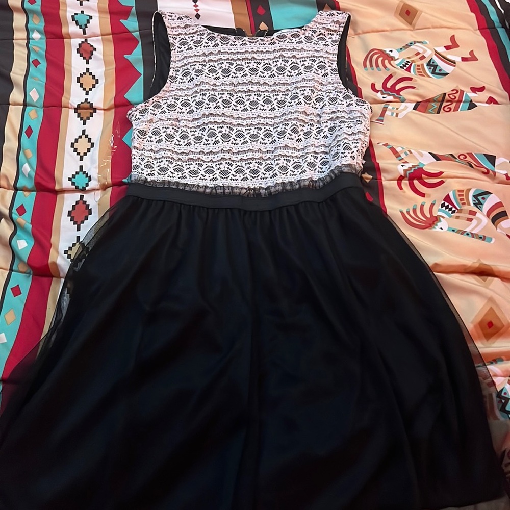 Black dress with little tan design patterns on the top